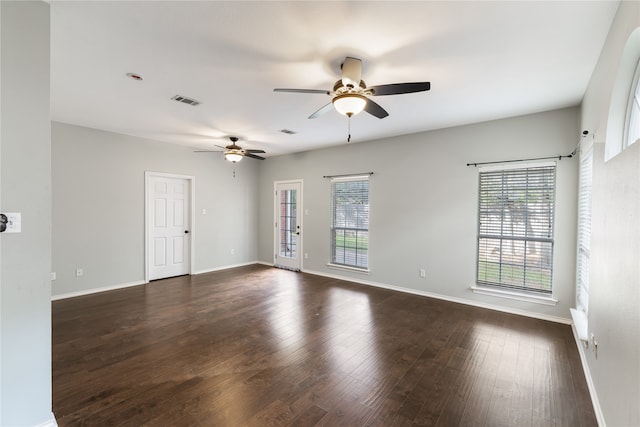 unfurnished room with dark wood-type flooring and ceiling fan