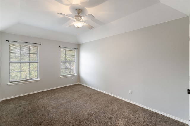 carpeted spare room featuring ceiling fan, a raised ceiling, and lofted ceiling