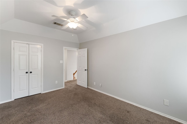 unfurnished bedroom with a closet, lofted ceiling, carpet, and ceiling fan