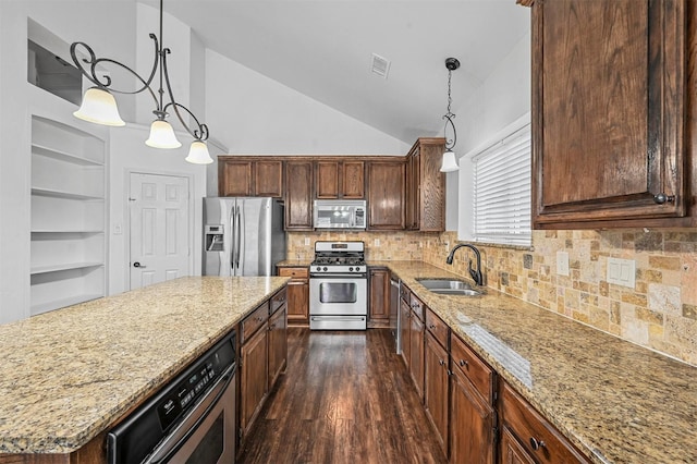 2221 Pittner Ln, Plano, TX 75025 - kitchen featuring stainless steel appliances, a sink, light stone countertops, dark wood-type flooring, and high vaulted ceiling