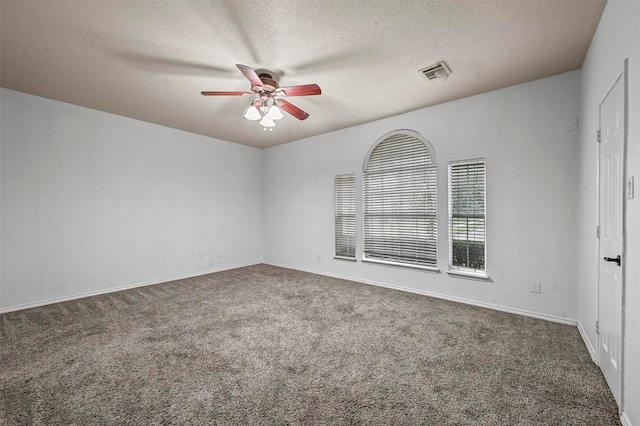 carpeted spare room with a textured ceiling and ceiling fan