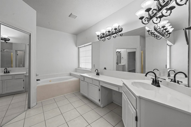 bathroom with vanity, a textured ceiling, tile patterned flooring, and plus walk in shower