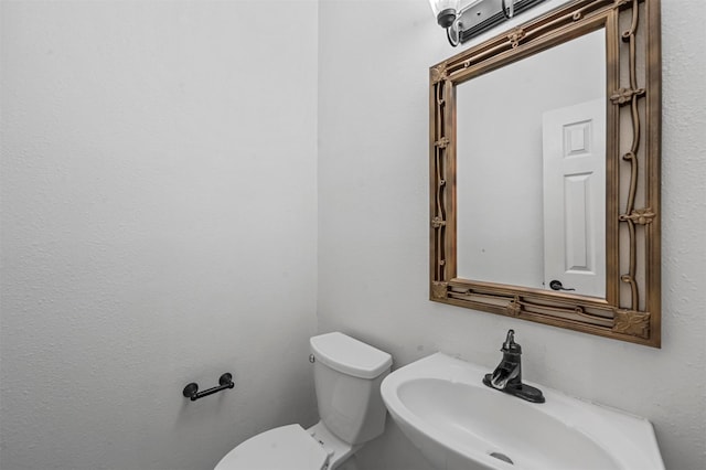 bathroom featuring toilet and sink