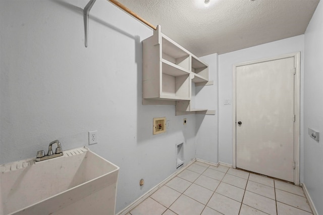 washroom featuring hookup for a washing machine, sink, hookup for an electric dryer, a textured ceiling, and light tile patterned floors