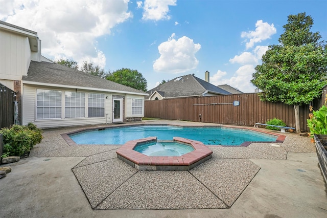 view of pool with an in ground hot tub and a patio area