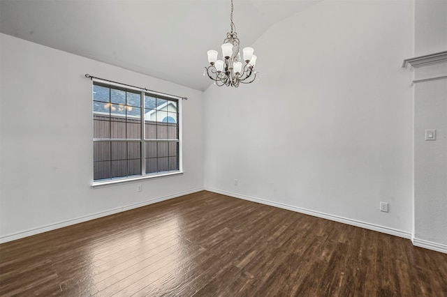 spare room with a notable chandelier, hardwood / wood-style flooring, and vaulted ceiling