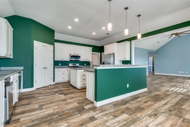 kitchen with ceiling fan, hardwood / wood-style flooring, white cabinets, and appliances with stainless steel finishes