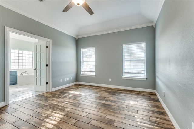 unfurnished room featuring ceiling fan, french doors, light hardwood / wood-style flooring, lofted ceiling, and ornamental molding