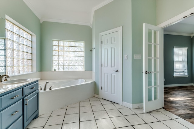 bathroom with ornamental molding, a tub to relax in, and a wealth of natural light