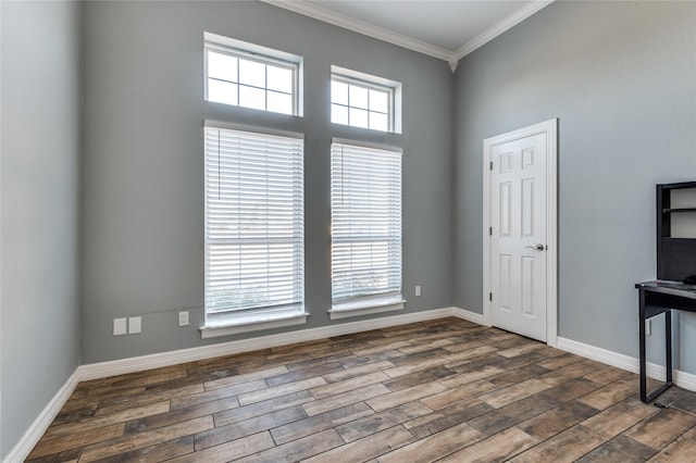 empty room featuring dark hardwood / wood-style flooring and ornamental molding