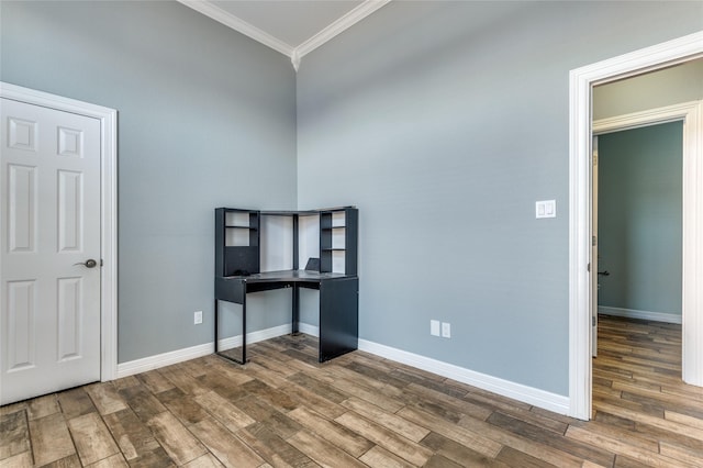 unfurnished office featuring hardwood / wood-style flooring and ornamental molding