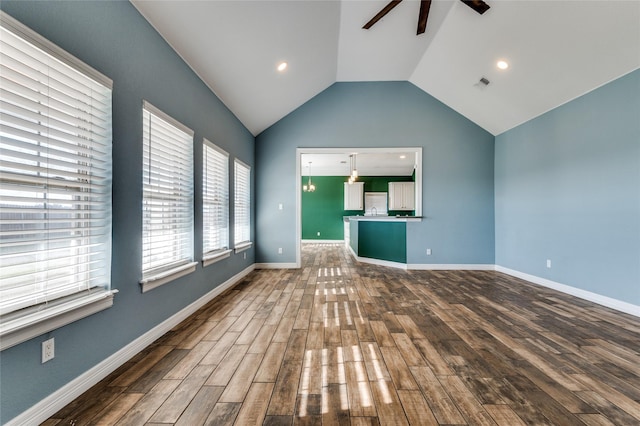 unfurnished living room featuring dark hardwood / wood-style floors, ceiling fan, and lofted ceiling