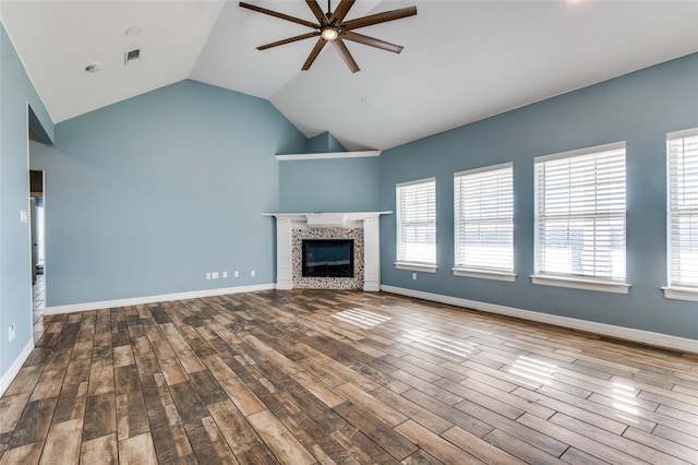 unfurnished living room featuring a fireplace, hardwood / wood-style floors, plenty of natural light, and ceiling fan