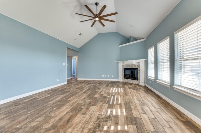 unfurnished living room with ceiling fan, high vaulted ceiling, and hardwood / wood-style flooring