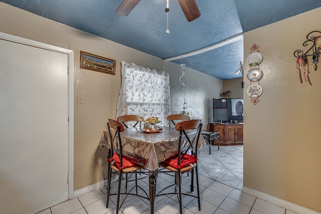 tiled dining area with ceiling fan