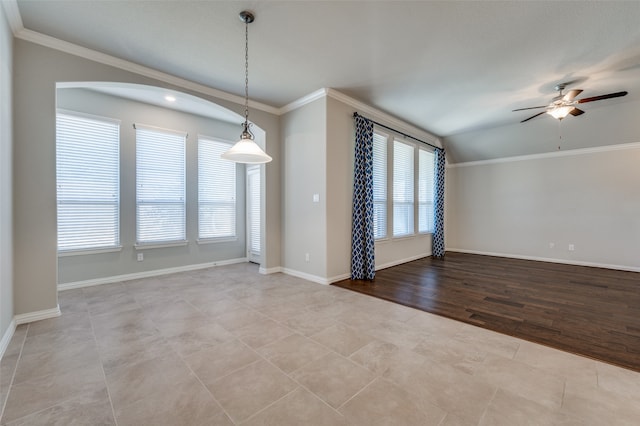 spare room featuring vaulted ceiling, ceiling fan, ornamental molding, and a healthy amount of sunlight