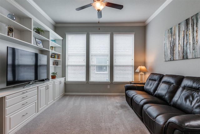 carpeted living room featuring ceiling fan and crown molding