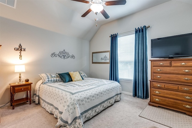 carpeted bedroom with ceiling fan and vaulted ceiling