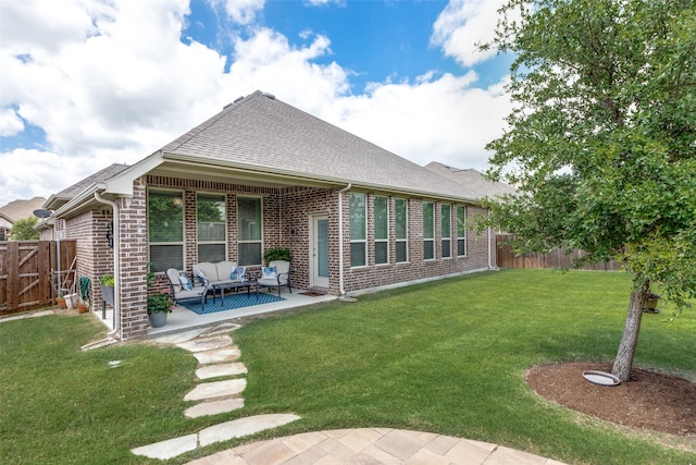 back of house with outdoor lounge area, a yard, and a patio