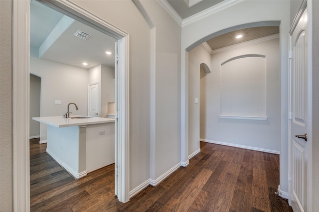 corridor with sink, dark hardwood / wood-style flooring, and crown molding