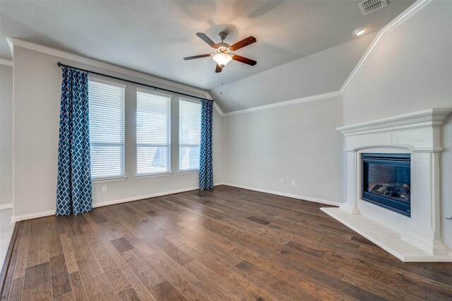 unfurnished living room featuring ceiling fan, dark hardwood / wood-style flooring, ornamental molding, and vaulted ceiling