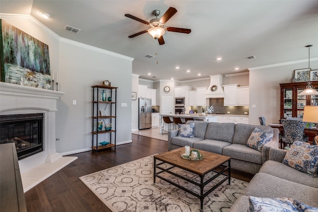 living room with ceiling fan, dark hardwood / wood-style flooring, crown molding, and lofted ceiling