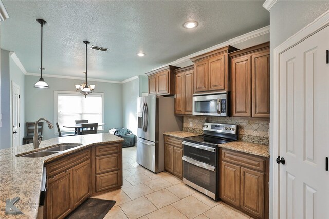 kitchen featuring ornamental molding, stainless steel appliances, decorative light fixtures, an inviting chandelier, and sink