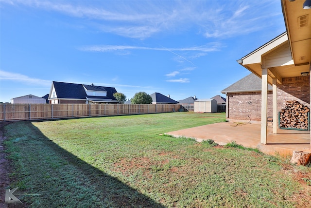 view of yard with a patio and a shed