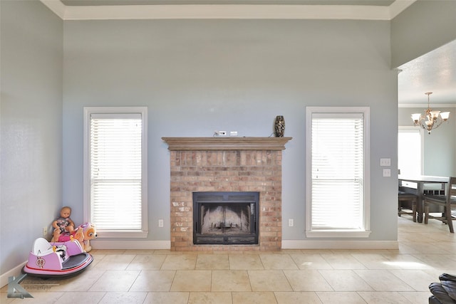 tiled living room with ornamental molding, a fireplace, and an inviting chandelier