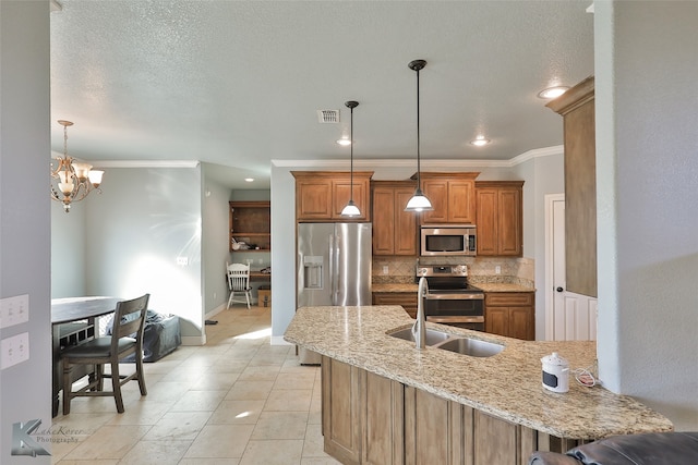 kitchen featuring tasteful backsplash, appliances with stainless steel finishes, pendant lighting, an inviting chandelier, and a kitchen breakfast bar