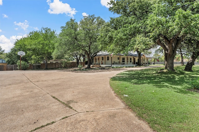 exterior space with covered porch and a front yard