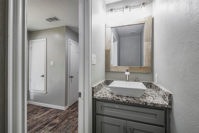 bathroom with vanity and hardwood / wood-style floors