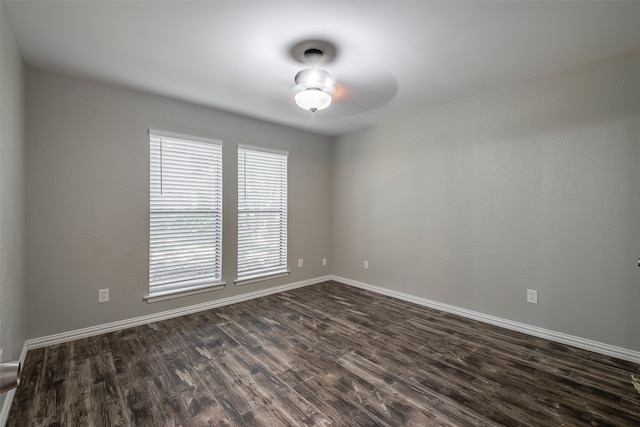 spare room with ceiling fan and dark hardwood / wood-style floors