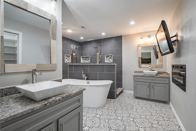 bathroom with vanity and shower with separate bathtub