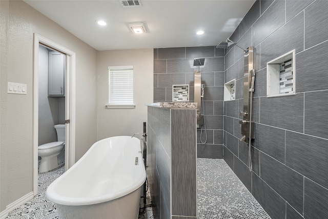 bathroom featuring toilet, tile patterned floors, and separate shower and tub