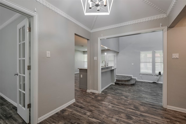 hallway with ornamental molding, sink, vaulted ceiling, and dark hardwood / wood-style floors