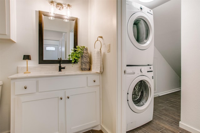 clothes washing area with sink and stacked washer and dryer