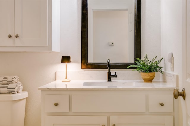 bathroom with vanity and toilet