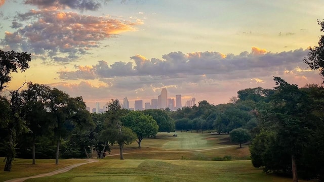 surrounding community with a view of city and a yard