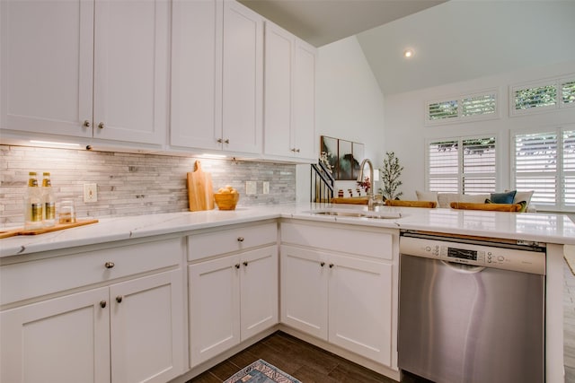 kitchen featuring decorative backsplash, dishwasher, lofted ceiling, dark wood-type flooring, and a sink