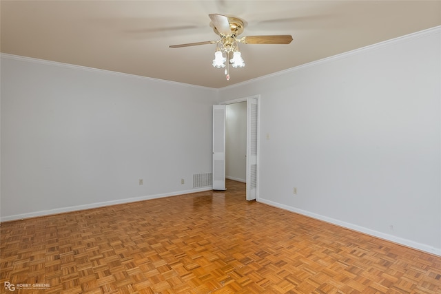 empty room with ornamental molding, light parquet floors, and ceiling fan