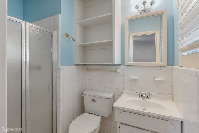 bathroom featuring vanity, toilet, walk in shower, and tile walls