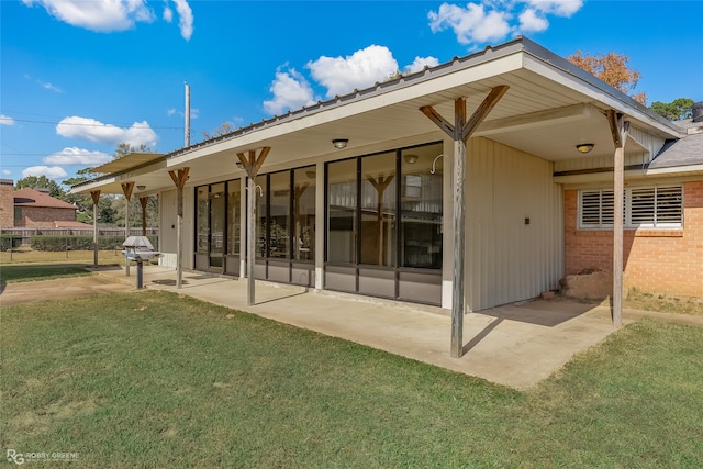 rear view of house with a yard and a patio