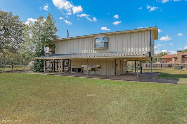 rear view of property with a lawn