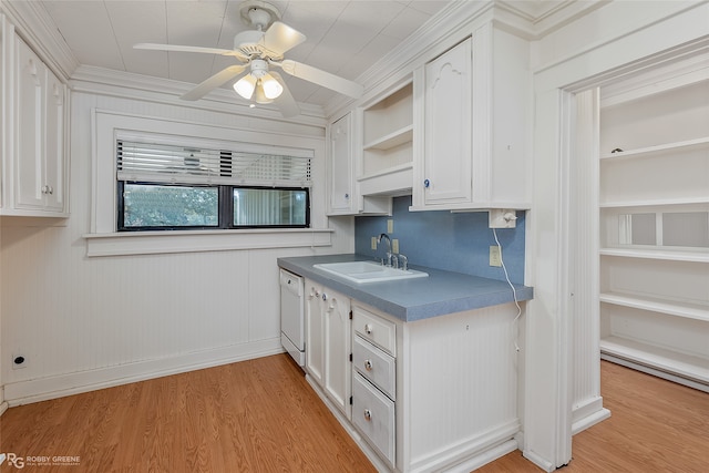 kitchen with light hardwood / wood-style floors, white cabinets, dishwasher, and sink