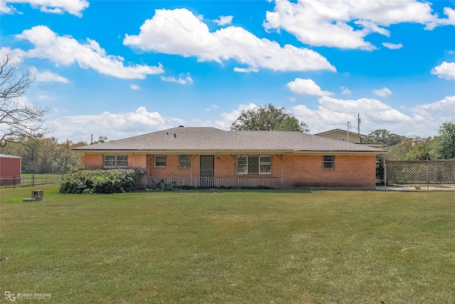 rear view of property featuring a yard