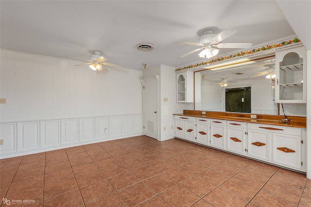 bathroom featuring vanity, wooden walls, and tile patterned flooring