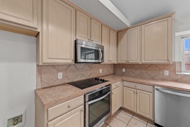 kitchen featuring backsplash, appliances with stainless steel finishes, and light tile patterned floors