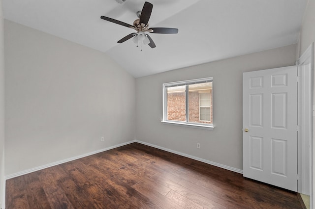 unfurnished bedroom featuring dark hardwood / wood-style floors, vaulted ceiling, and ceiling fan