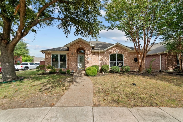 ranch-style home featuring a front yard